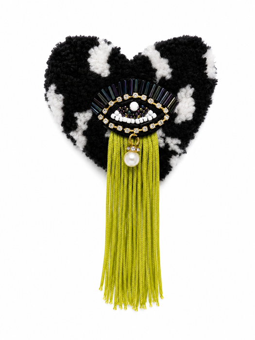 Handmade tufted brooch in black and white with beaded evil eye embellishment, chartreuse green fringe and pearl drop charm