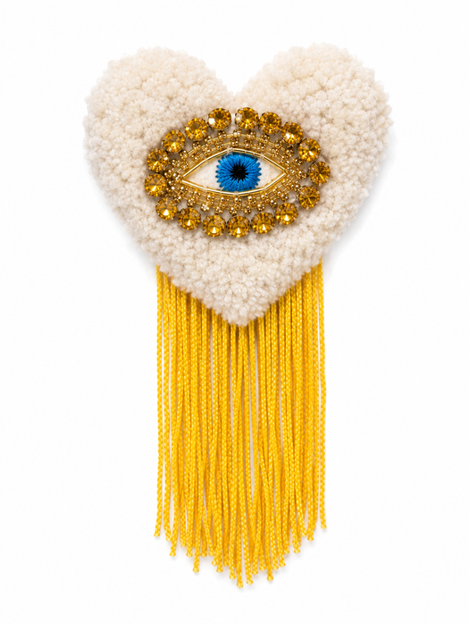 Handmade tufted brooch in cream with golden evil eye crystal embellishment and yellow fringe