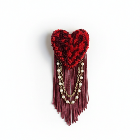 Clean minimal product photo of burgundy heart brooch with pearl chains