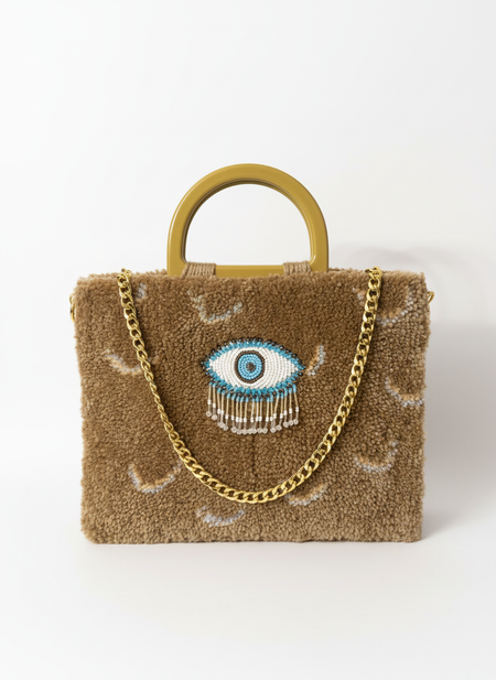 Luxury tufted handbag with beaded eye detail