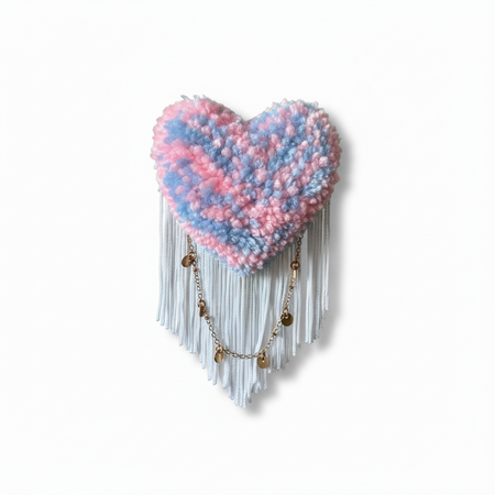 Pink and blue tufted heart brooch with natural lighting