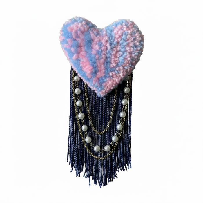 Pink and blue tufted heart brooch with soft realistic lighting