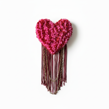 Pink and burgundy tufted heart brooch with soft lighting