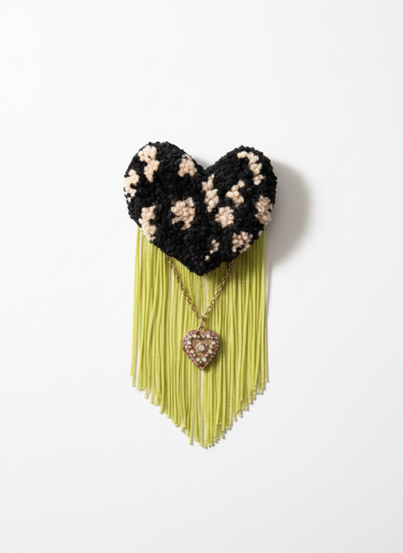 Professional product photo of black polka dot brooch with chartreuse fringe