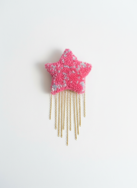 Professional product photo of pink star with brass chain fringe