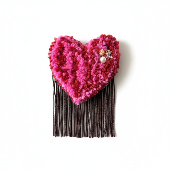 Professional product photo of pink tufted heart brooch