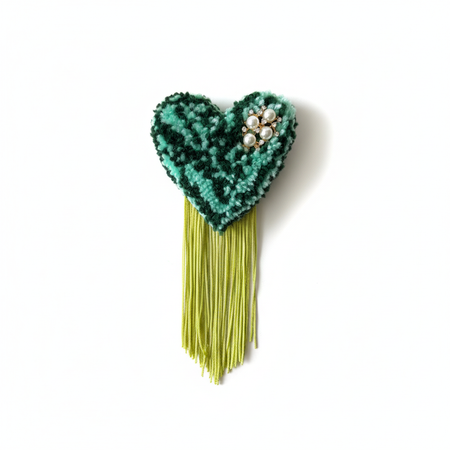 Professional product photo of teal and mint green tufted heart brooch with lime fringe